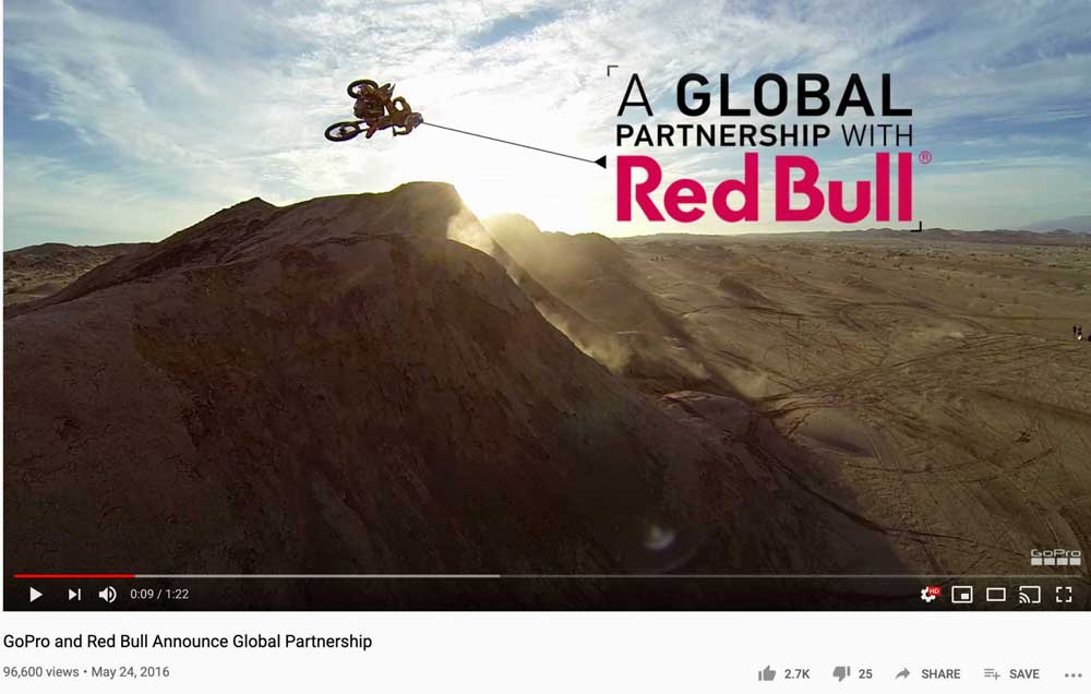 A screenshot from a YouTube video announcing the partnership between GoPro and Red Bull, which shows a BMX rider catching air on a jump. Red Bull and GoPro's strategic alliance example.