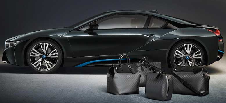 A promotional picture of the BMW i8 next to the matching Louis Vuitton bags